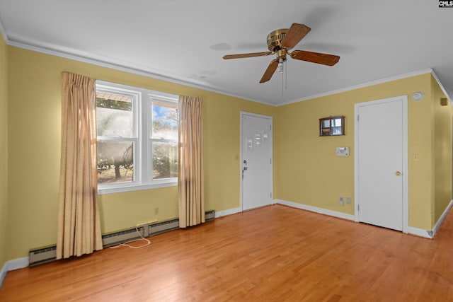 interior space featuring baseboards, a ceiling fan, light wood-style flooring, ornamental molding, and a baseboard heating unit