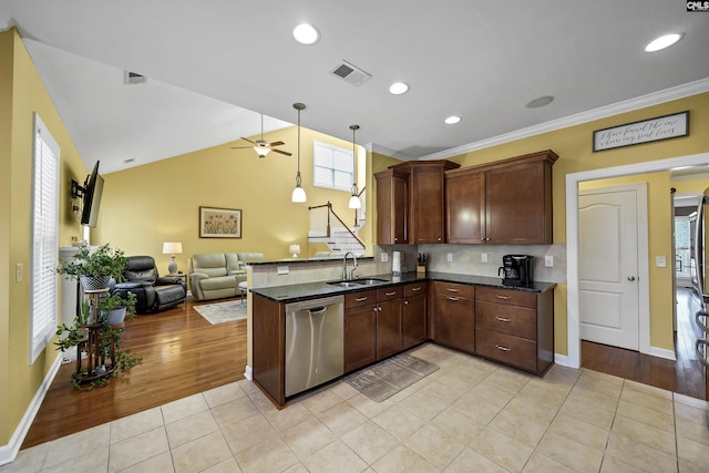 kitchen featuring visible vents, stainless steel dishwasher, open floor plan, a sink, and a peninsula