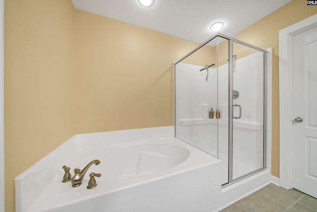 full bathroom with a garden tub, tile patterned floors, and a stall shower