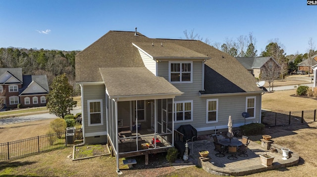 back of house featuring a shingled roof, a sunroom, a fenced backyard, crawl space, and a patio area