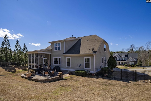 back of property featuring a yard, a patio area, fence, and a sunroom