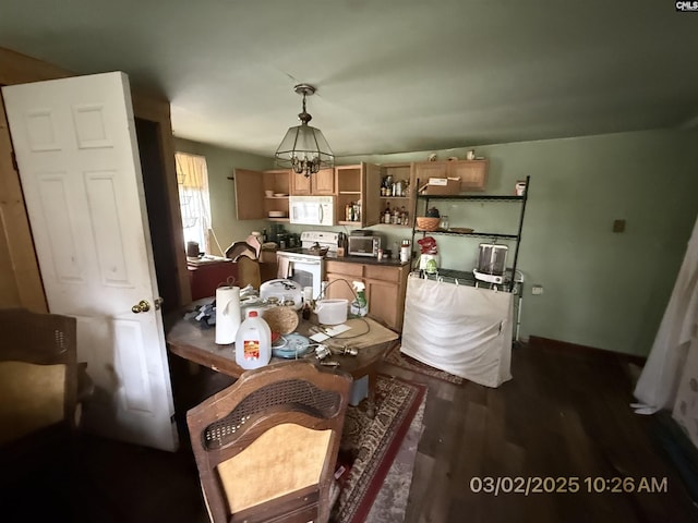 dining area featuring dark wood-style flooring and a notable chandelier