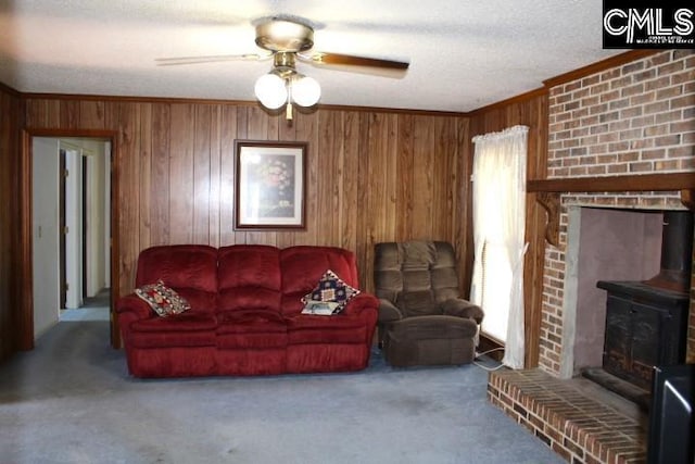 living area with carpet floors, wood walls, and crown molding