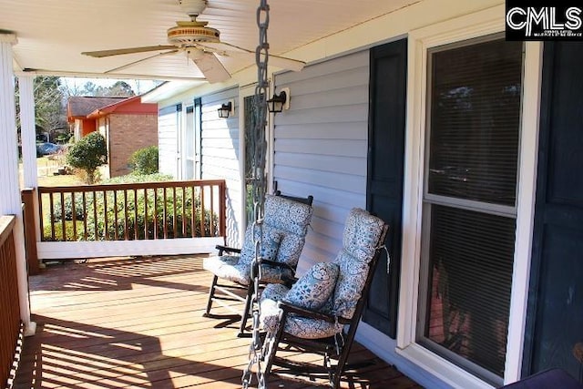 wooden deck with covered porch and ceiling fan