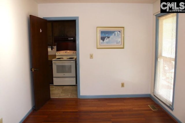 interior space featuring baseboards, visible vents, and wood finished floors