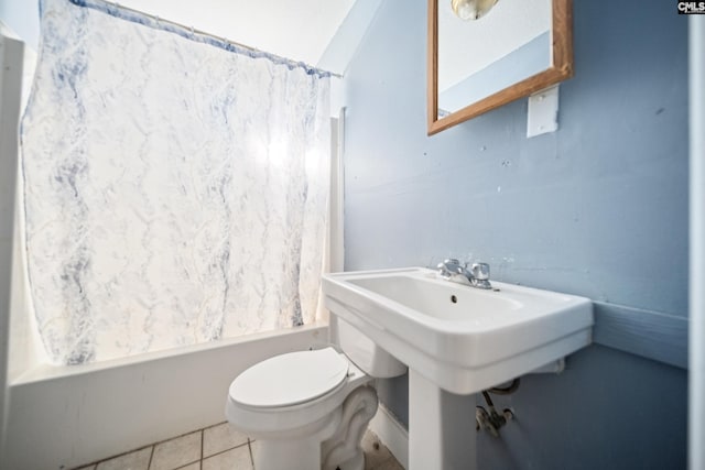 full bathroom with toilet, shower / bathtub combination with curtain, and tile patterned floors