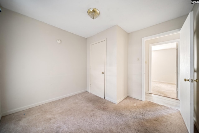 unfurnished bedroom featuring carpet flooring and baseboards