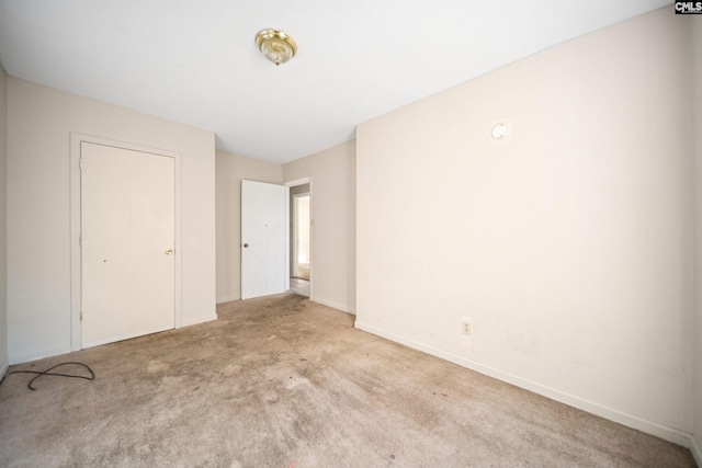 unfurnished bedroom featuring carpet and baseboards