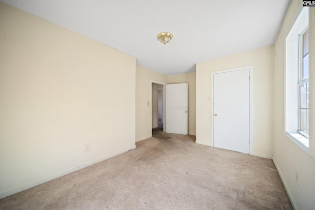 unfurnished bedroom featuring baseboards and carpet flooring