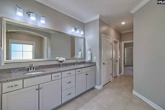 full bath featuring crown molding, a sink, and baseboards