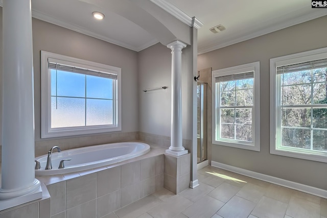 bathroom featuring ornamental molding, plenty of natural light, a garden tub, and ornate columns