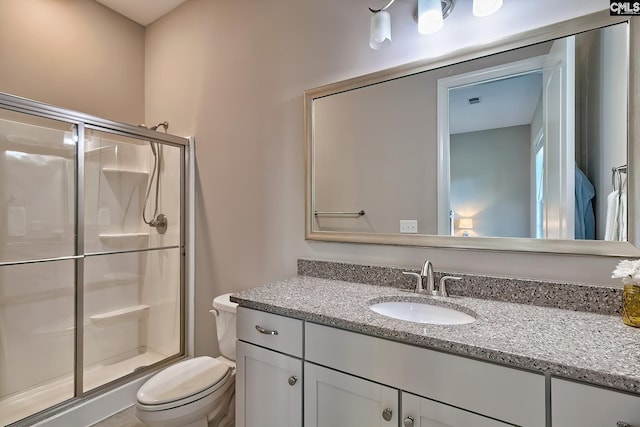 full bath with toilet, a shower stall, and vanity