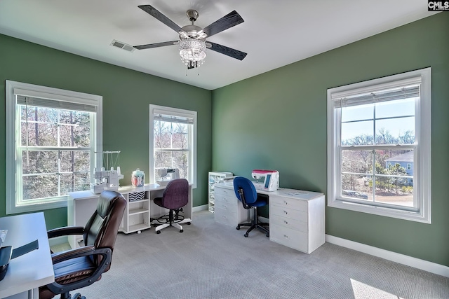 office featuring a ceiling fan, baseboards, visible vents, and carpet flooring