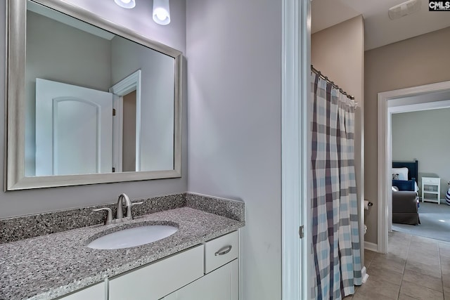 bathroom featuring curtained shower, tile patterned flooring, and vanity