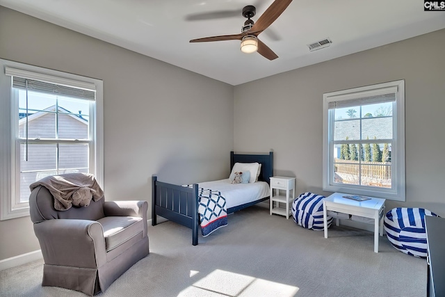 bedroom with baseboards, carpet flooring, visible vents, and a ceiling fan