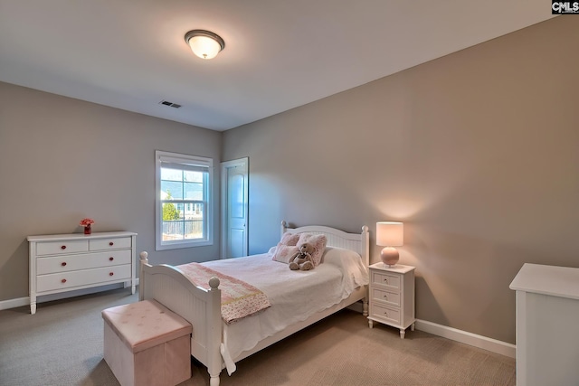 carpeted bedroom with visible vents and baseboards