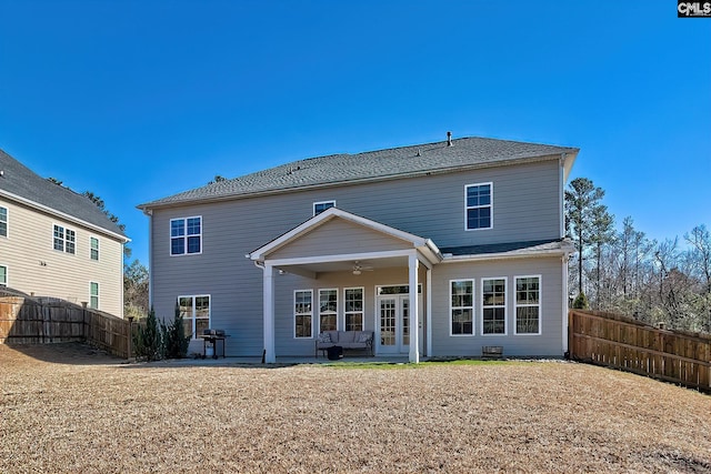 rear view of property featuring ceiling fan, a fenced backyard, and a patio