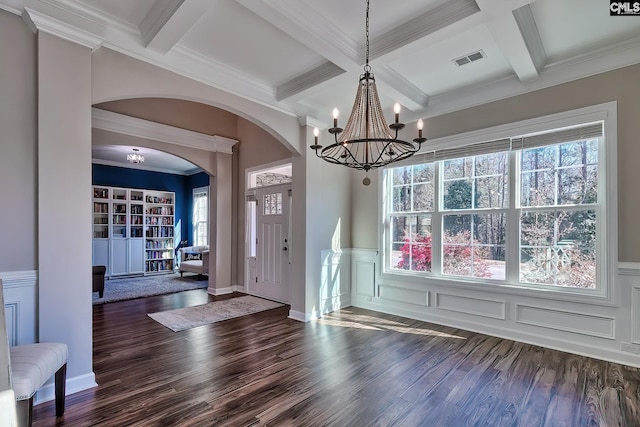 interior space featuring dark wood-type flooring, beam ceiling, visible vents, and coffered ceiling