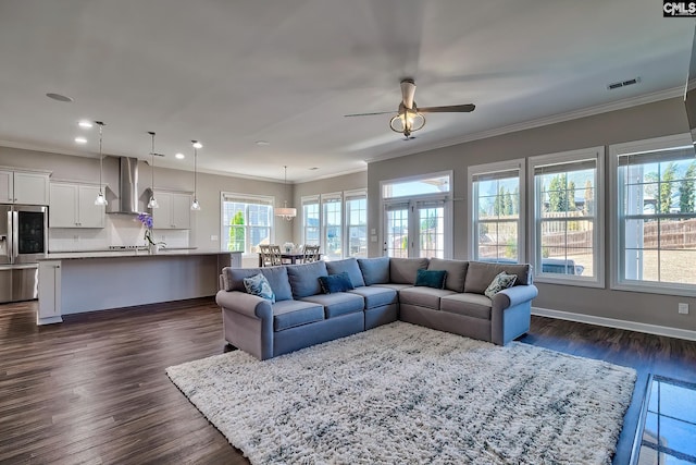 living area featuring ornamental molding, dark wood-style flooring, visible vents, and baseboards