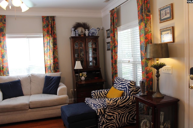 living area featuring visible vents and crown molding