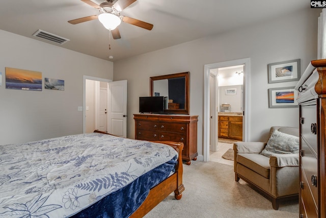 bedroom featuring light carpet, ceiling fan, visible vents, and connected bathroom