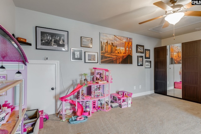 recreation room featuring carpet, baseboards, and ceiling fan