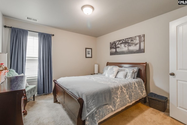 bedroom featuring light carpet and visible vents