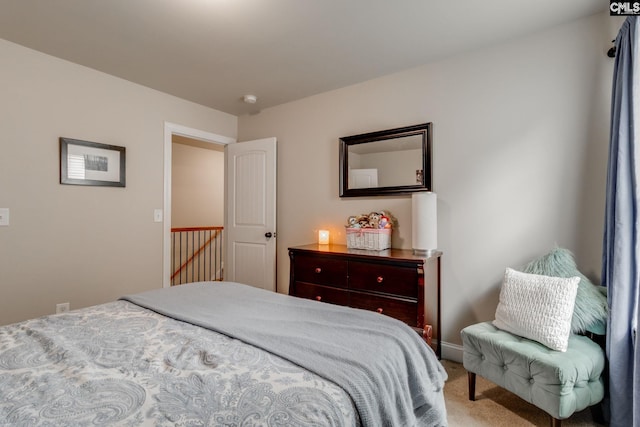 bedroom with carpet floors and baseboards