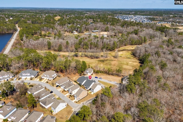 bird's eye view with a residential view, a water view, and a forest view