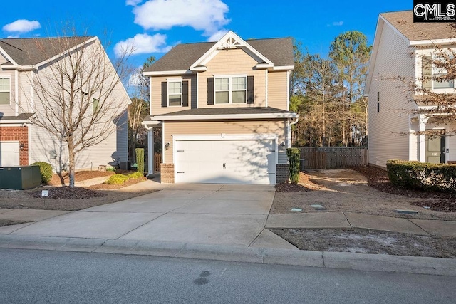 view of front of home featuring concrete driveway, brick siding, an attached garage, and fence