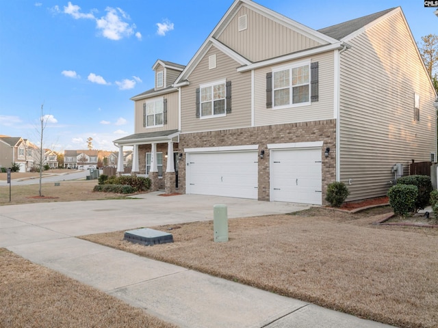 view of front of house with brick siding, driveway, and an attached garage