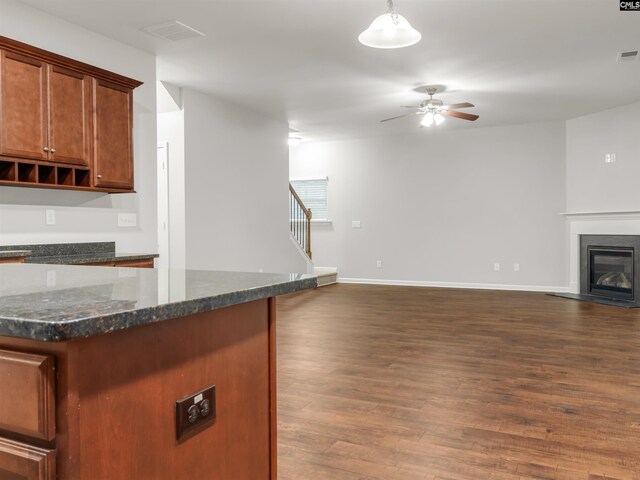 1124 Campbell Ridge Dr, Elgin, SC 29045 - kitchen featuring visible vents, dark wood-type flooring, a glass covered fireplace, open floor plan, and ceiling fan