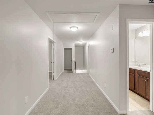 1124 Campbell Ridge Dr, Elgin, SC 29045 - corridor featuring attic access, light carpet, a sink, and baseboards