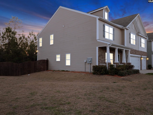 1124 Campbell Ridge Dr, Elgin, SC 29045 - property exterior at dusk featuring a garage, a yard, a porch, and fence