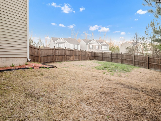 view of yard with a fenced backyard and a residential view