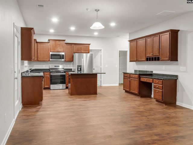 1124 Campbell Ridge Dr, Elgin, SC 29045 - kitchen with appliances with stainless steel finishes, dark wood-style flooring, a sink, and built in desk