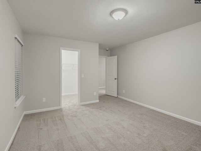 1124 Campbell Ridge Dr, Elgin, SC 29045 - unfurnished bedroom with carpet, baseboards, a walk in closet, and a closet