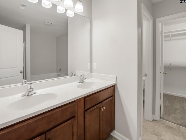 1124 Campbell Ridge Dr, Elgin, SC 29045 - bathroom featuring double vanity, a sink, visible vents, and a walk in closet