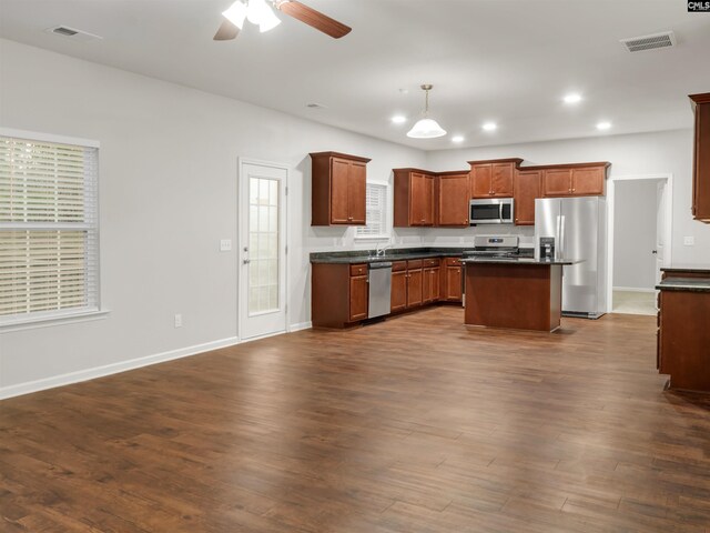 1124 Campbell Ridge Dr, Elgin, SC 29045 - kitchen with dark wood-style floors, dark countertops, visible vents, appliances with stainless steel finishes, and open floor plan
