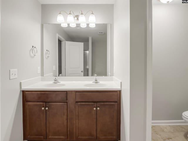 1124 Campbell Ridge Dr, Elgin, SC 29045 - bathroom with baseboards, a sink, toilet, and double vanity