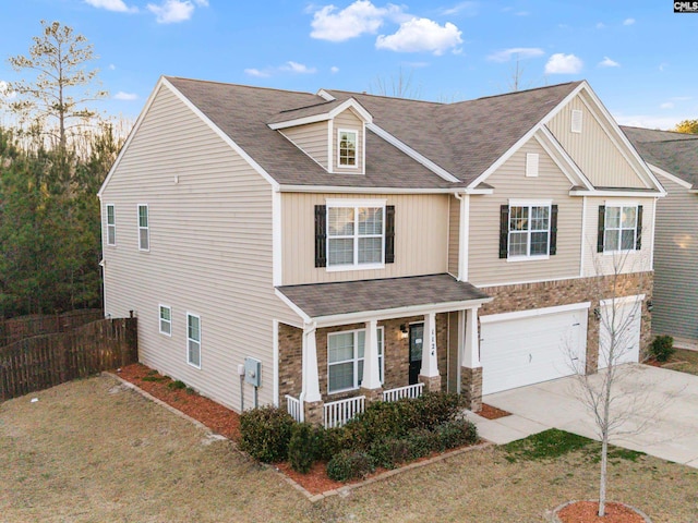 1124 Campbell Ridge Dr, Elgin, SC 29045 - view of front of home featuring driveway, stone siding, an attached garage, covered porch, and fence