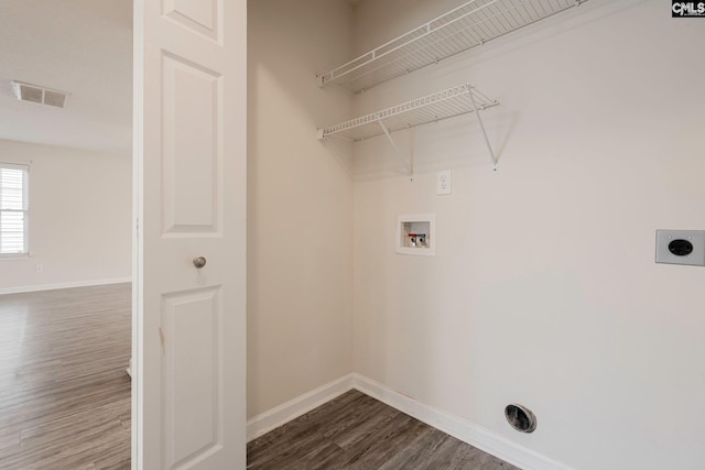 washroom with dark wood-style floors, baseboards, visible vents, and electric dryer hookup