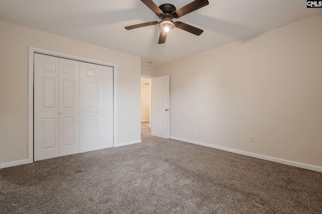 unfurnished bedroom featuring a textured ceiling, carpet floors, a closet, and baseboards