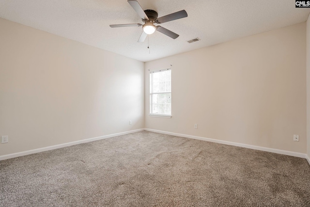 unfurnished room with a textured ceiling, ceiling fan, carpet flooring, visible vents, and baseboards