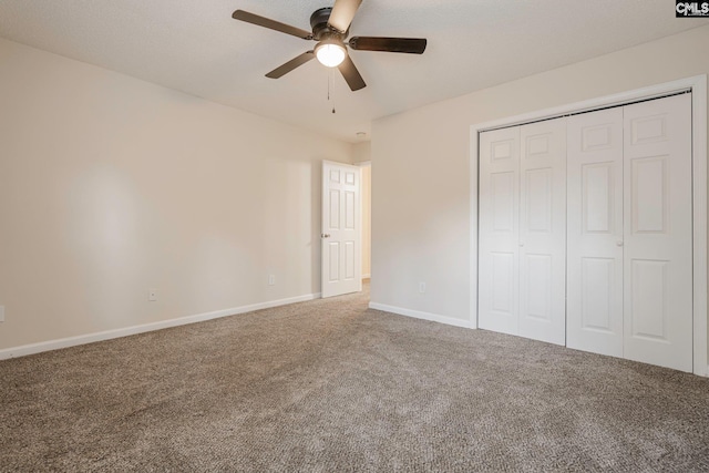 unfurnished bedroom with carpet, a closet, ceiling fan, and baseboards