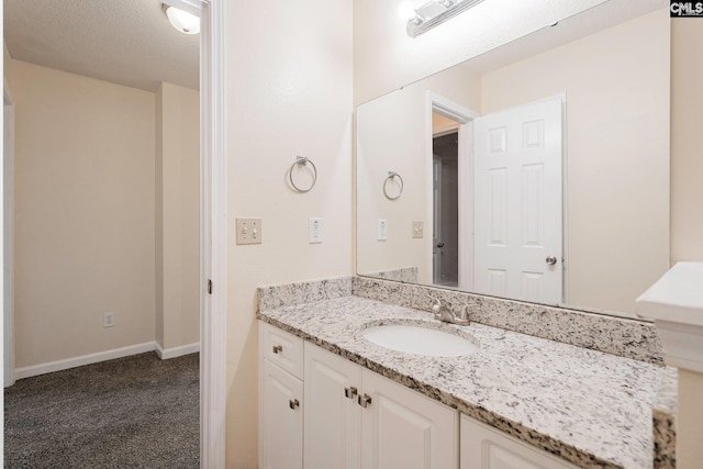 bathroom with vanity and baseboards