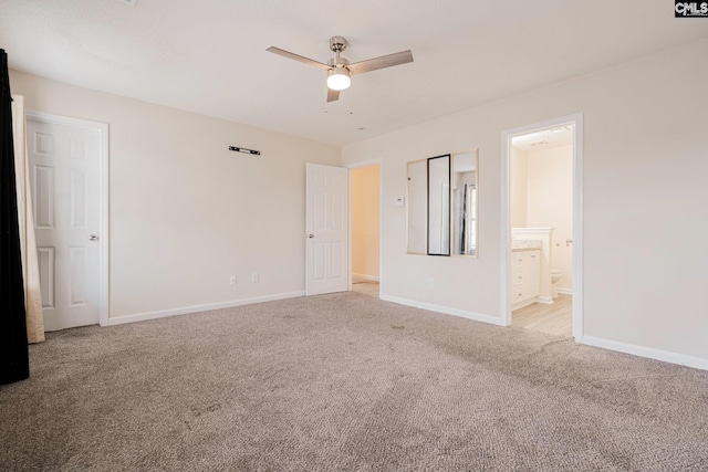 unfurnished bedroom featuring baseboards, ceiling fan, ensuite bathroom, and light colored carpet