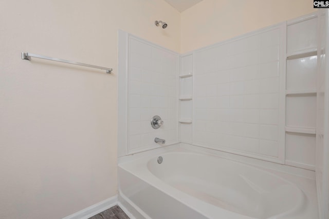 bathroom with baseboards and wood finished floors