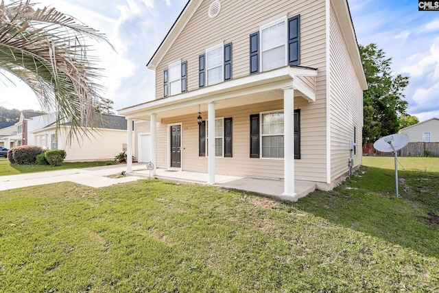 view of front of house featuring a garage, driveway, a front lawn, and a porch