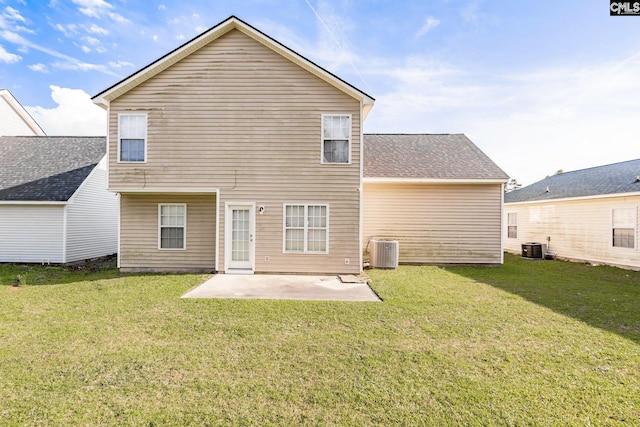 back of house featuring cooling unit, a lawn, and a patio